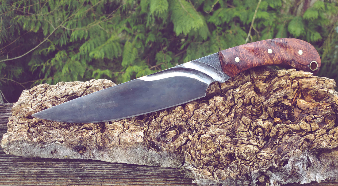 Fighter, 5160 with curved fullers. Honduran rosewood scales with brass. 