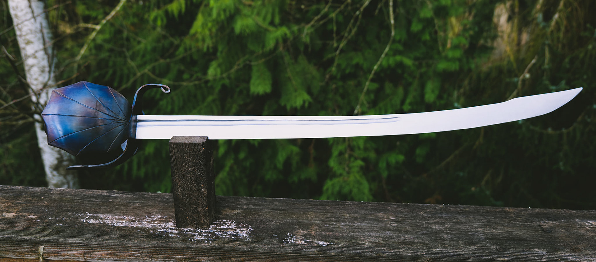 Cutlass, with double shell and S guard from a single piece, fireblued, with a moose antler grip. 34" oal with a 28 1/8" fullered blade