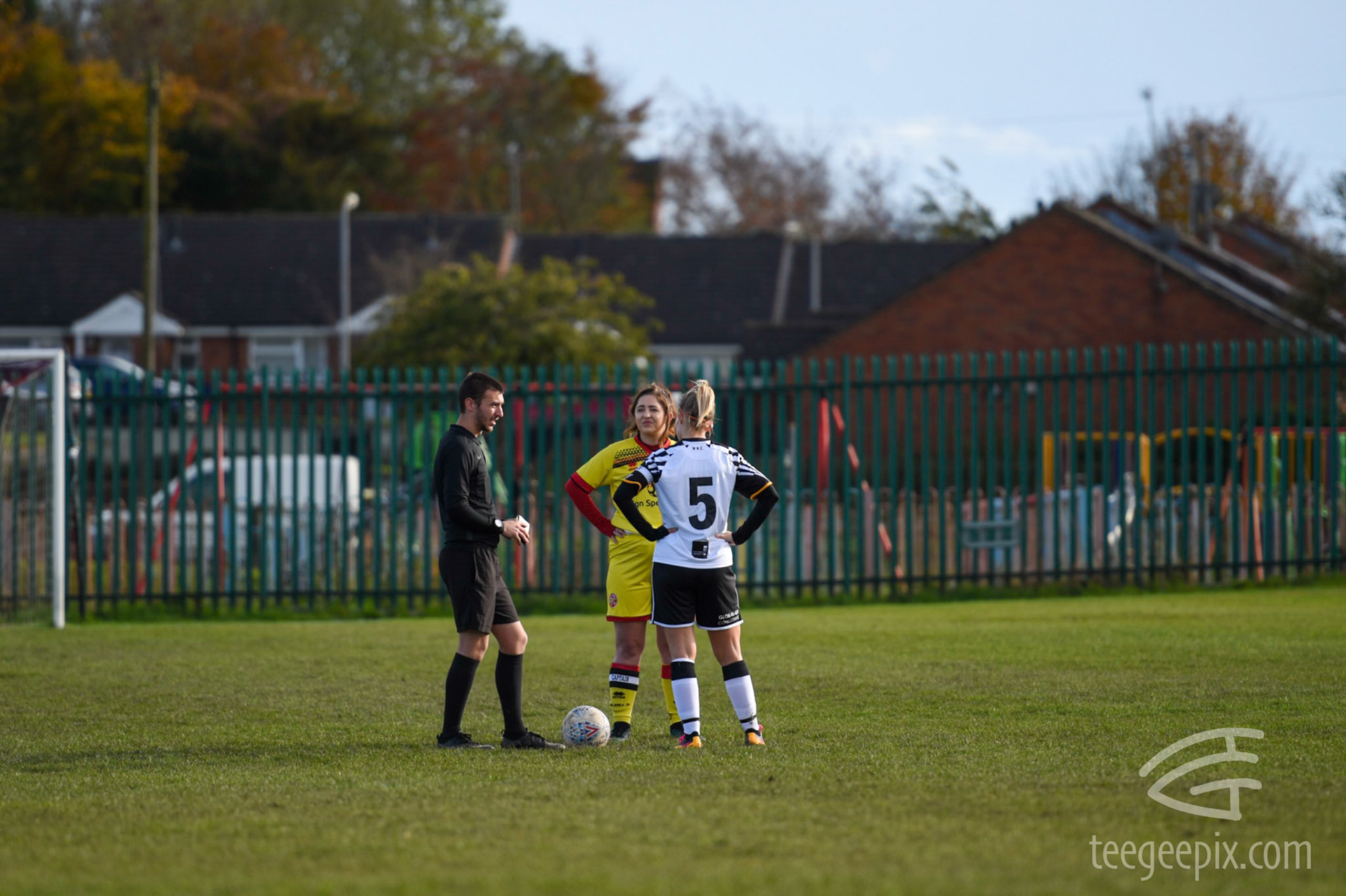 The two captains join the referee for the coin toss at the start of the game