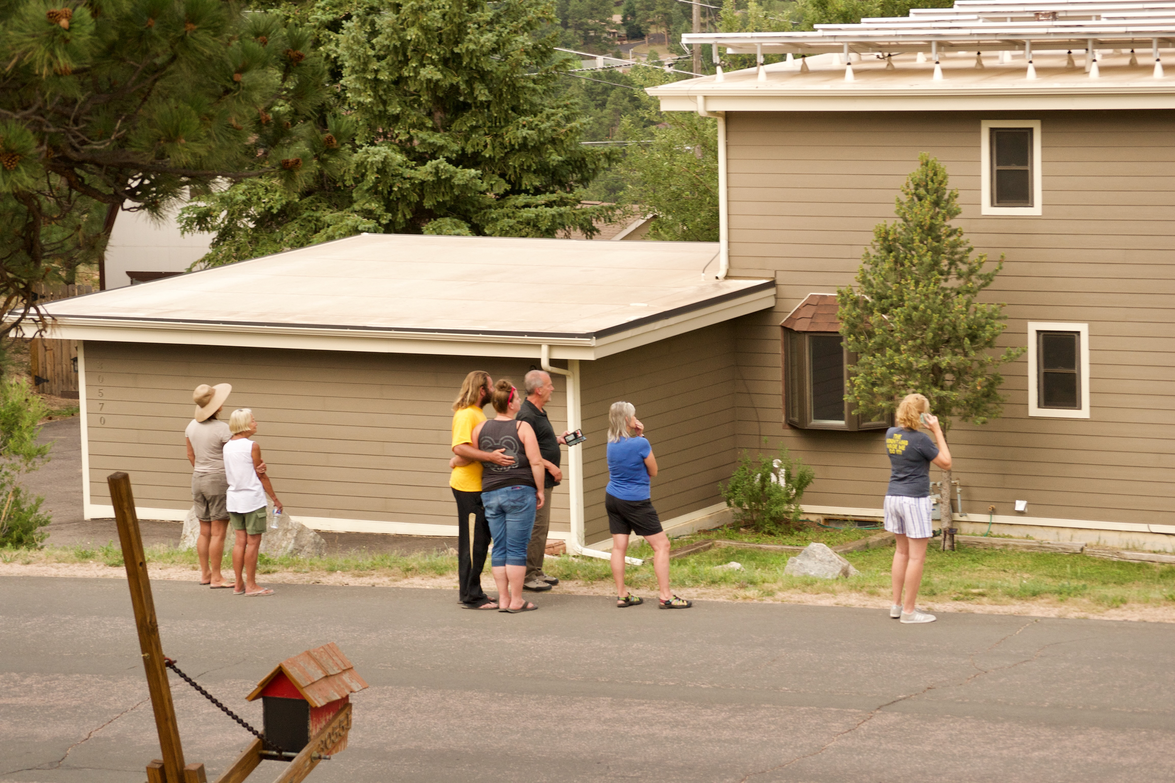 Residents of a nearby neighborhood watch the drama unfold © 2022 Geoffrey Erdahl