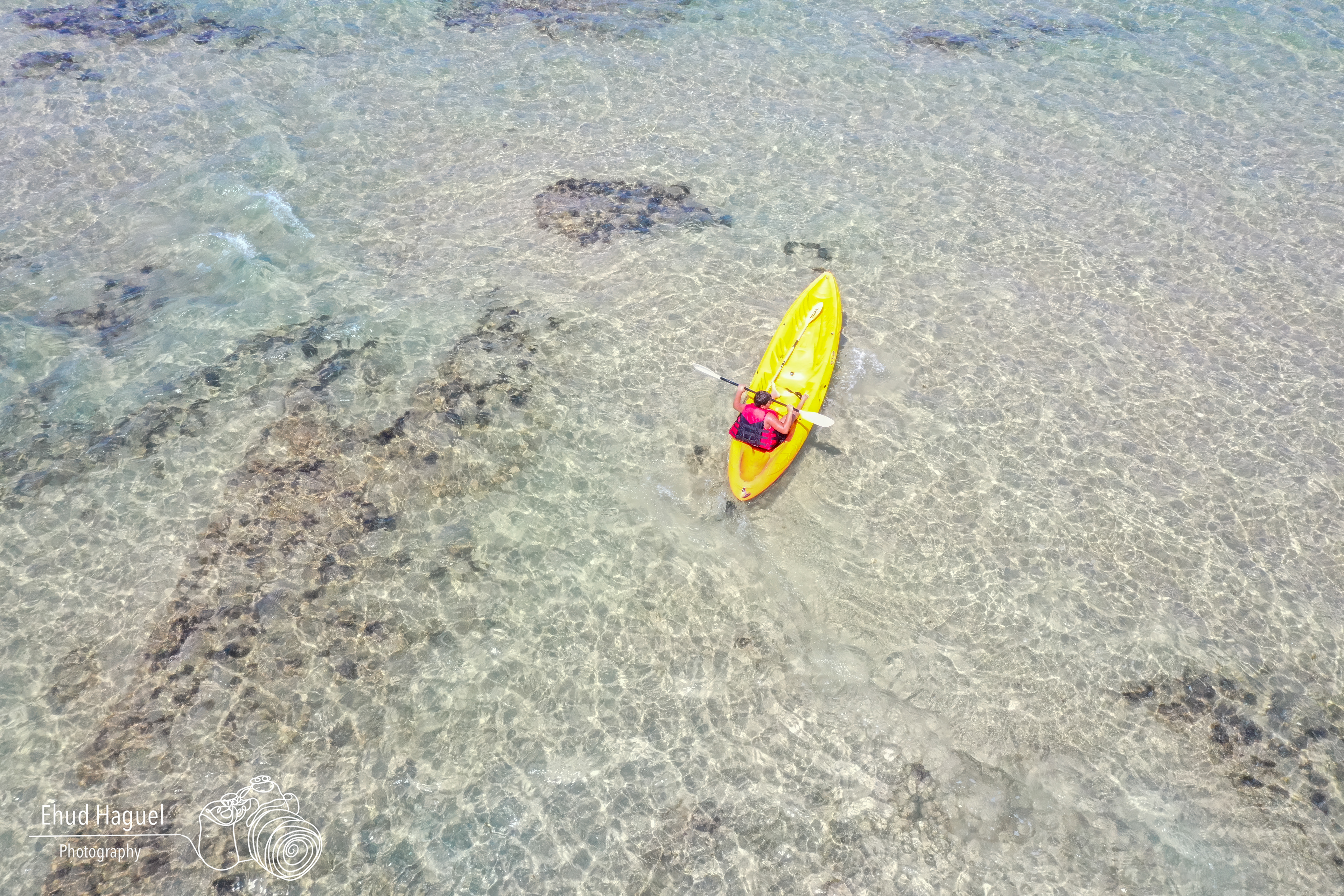Aerial view of kayak on clear shallow water, drone photography Israel