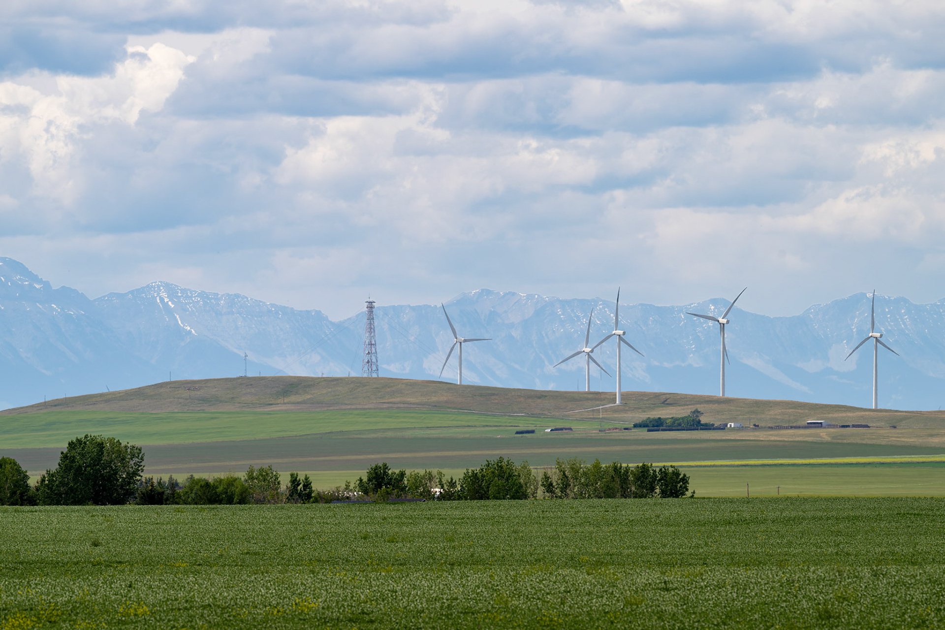 Wind turbines in the foreground of the Canadian Rocky Mountains near Pincher Creek, Alberta.