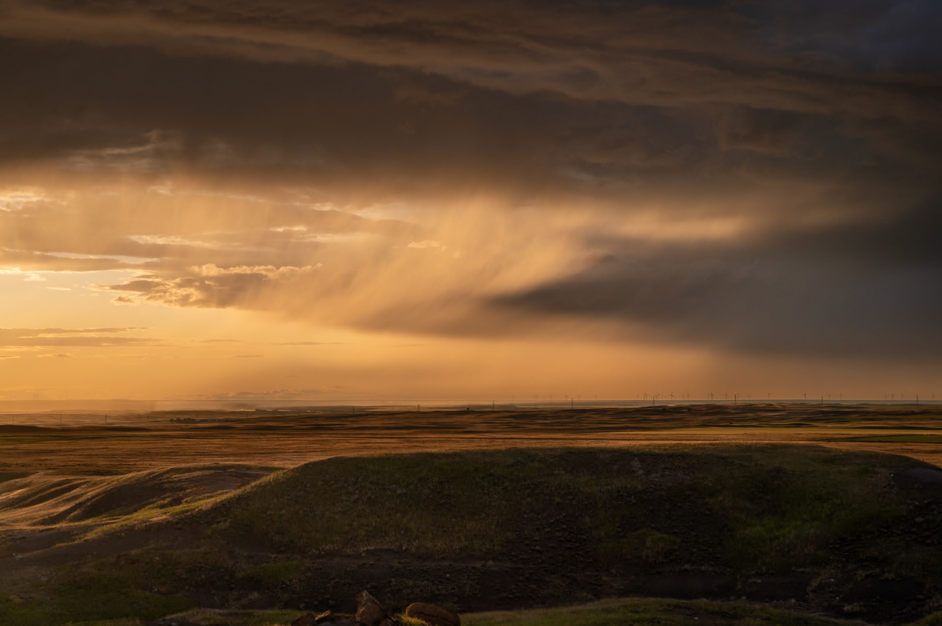 Thunderstorms move in the distance past Red Rock Coulee Natural Area in southern Alberta.