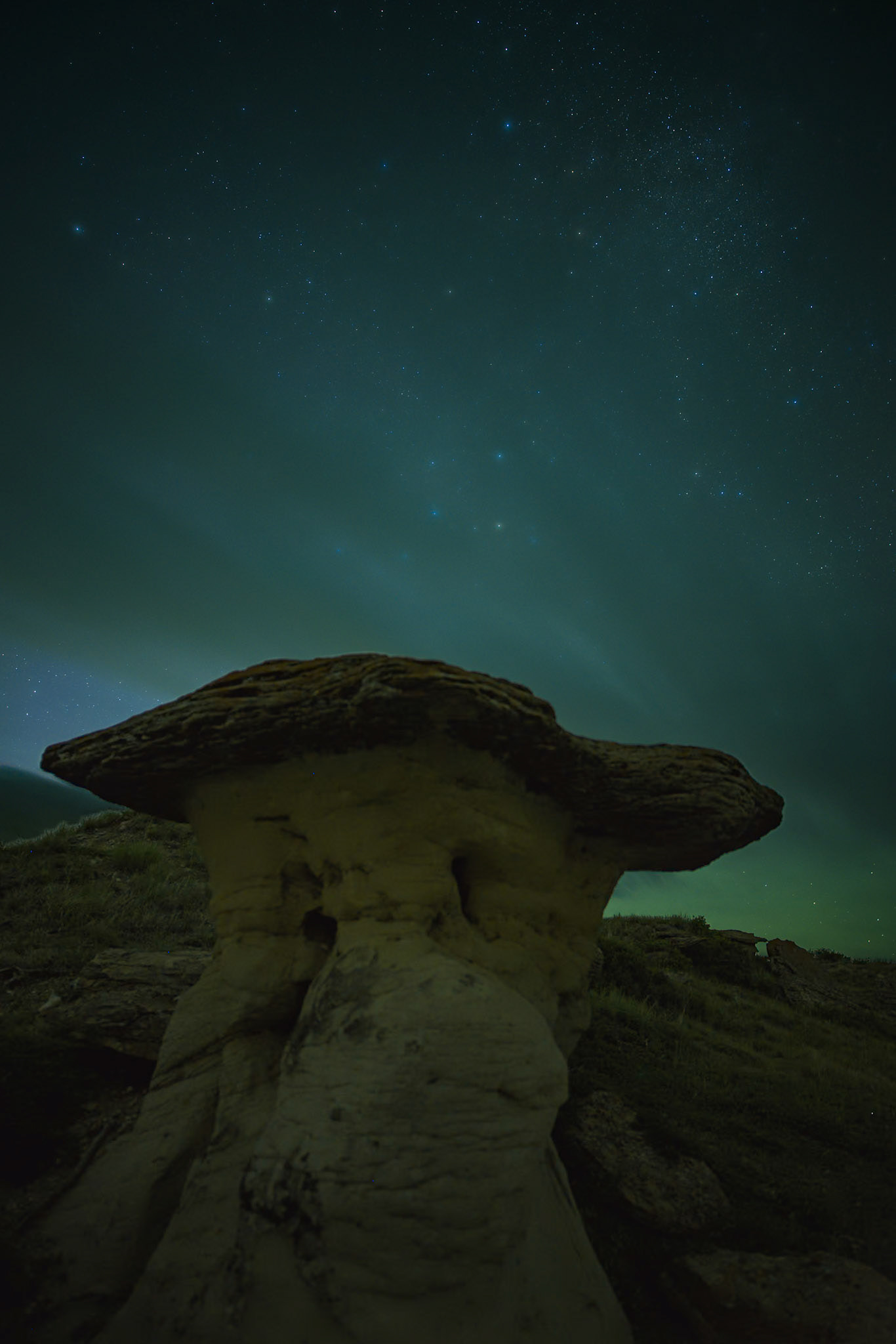 Faint clouds on a starlit night in Writing-on-Stone Provincial Park in Alberta.
