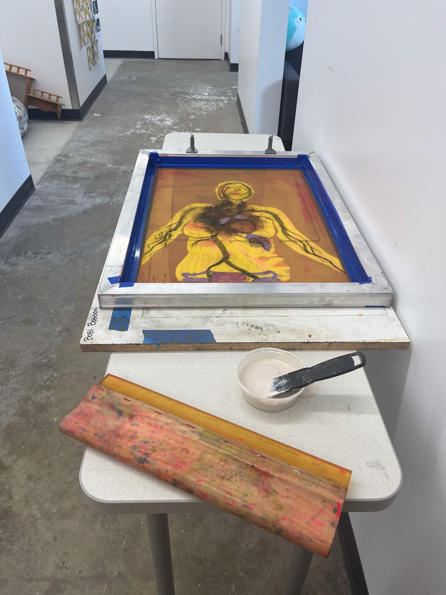 Prepping to flood screen with porcelain slip for a mono-serigraph.