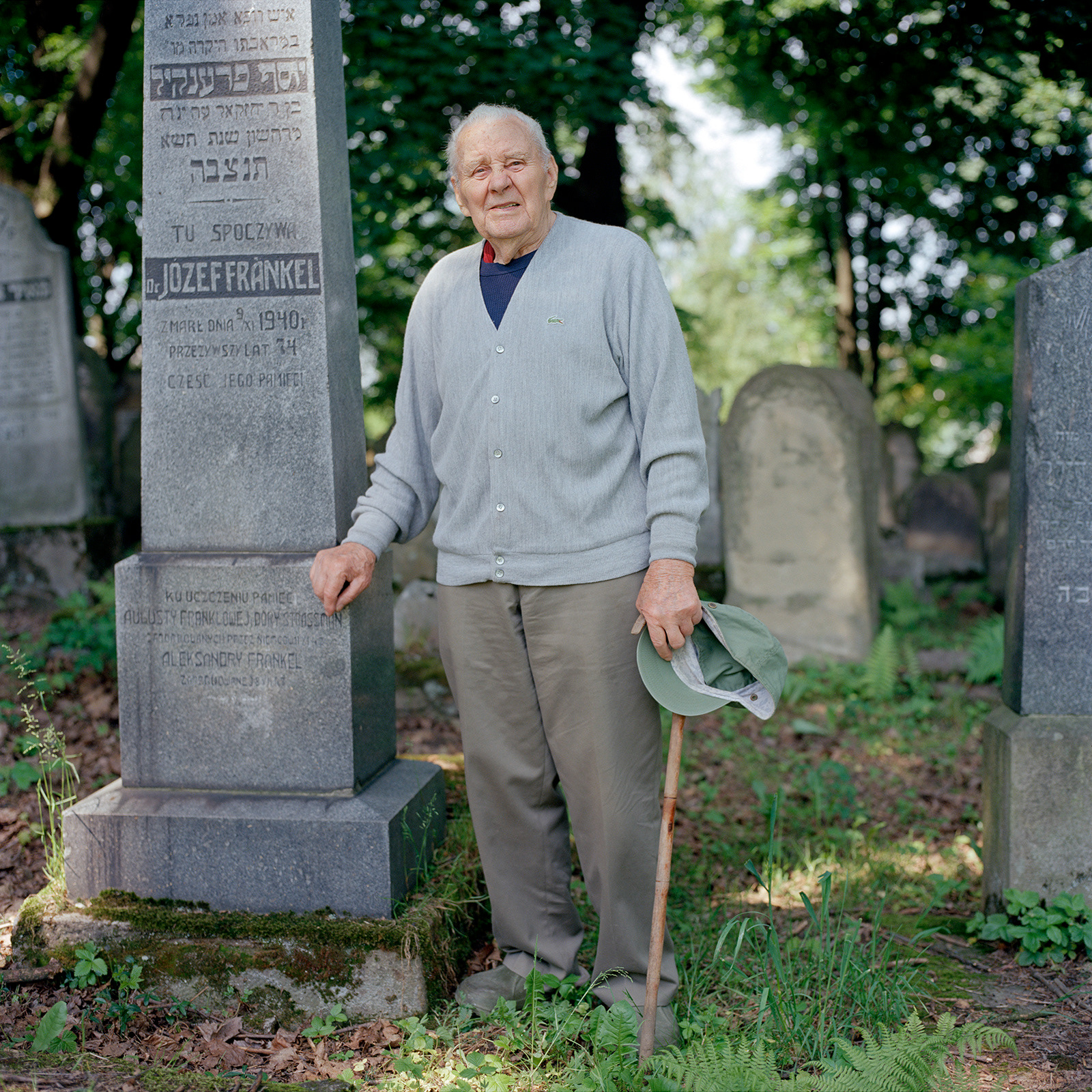 Leon Gawąd, Polish caretaker of the Jewish cemetery, Bochnia. Gawąd is pictured standing by the grave of Josef Frankel, his childhood doctor, and in fact the person who delivered him.