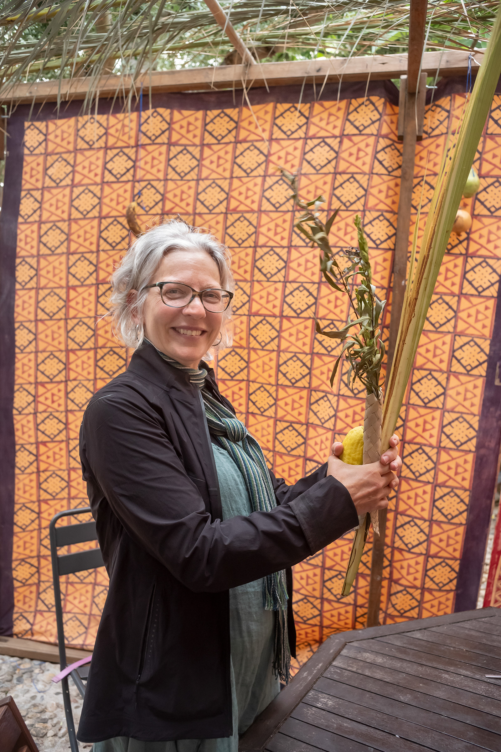 Jason Francisco / A visitor shaking the lulav in the sukkah of Etz Hayyim, 2022