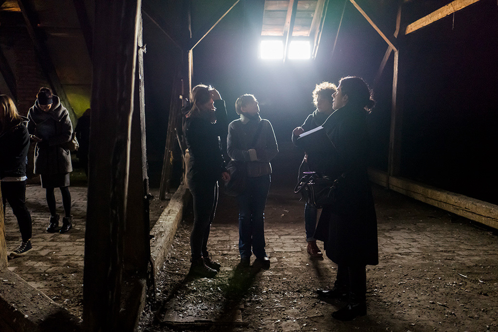 Students tour the attic of the Gmina building, hiding place during the war, Kazimierz, Kraków
