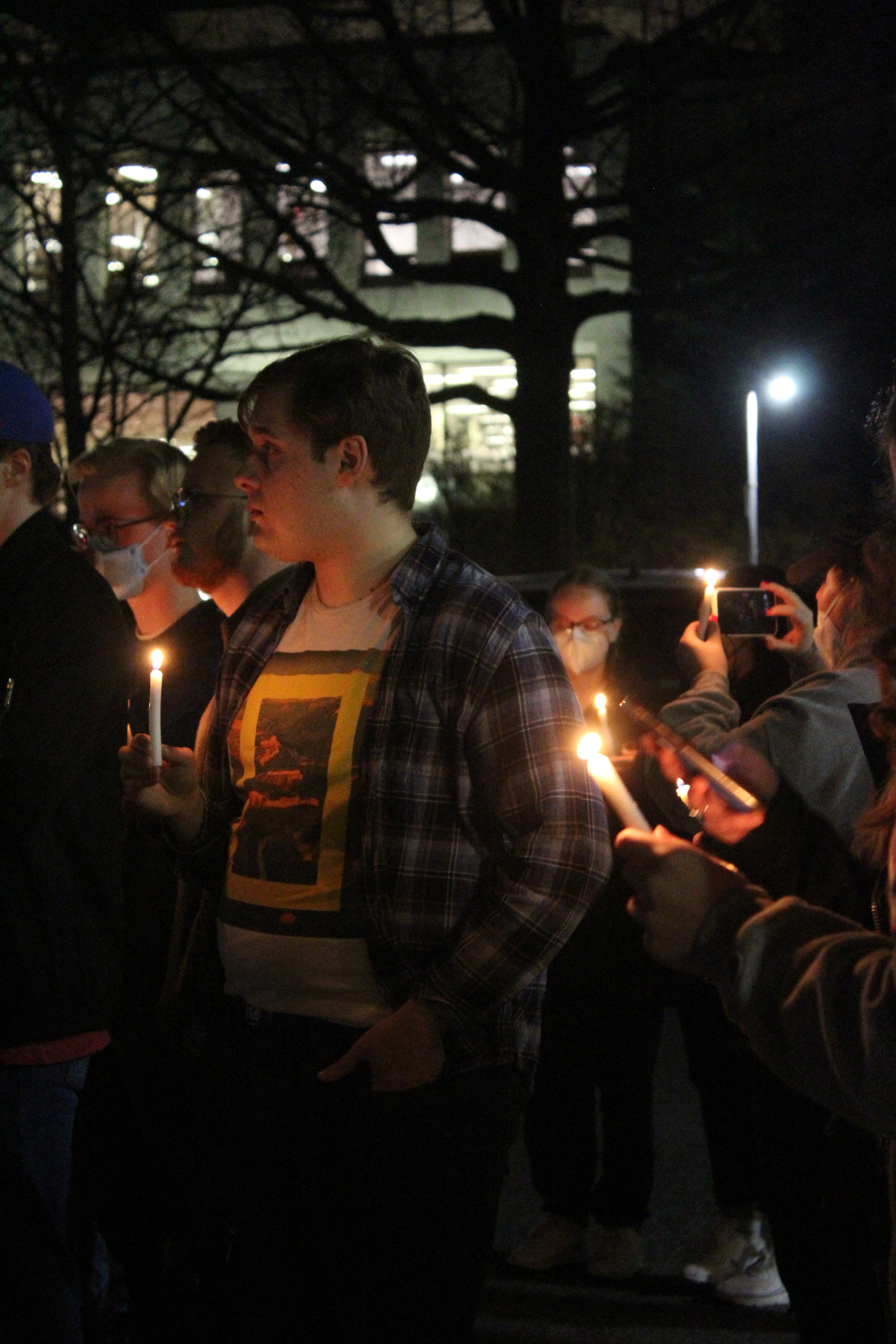 A student stands amid the candlelight in support of Ukraine in Washington, D.C. on March 2, 2022. (Lia Chien/The Eagle)