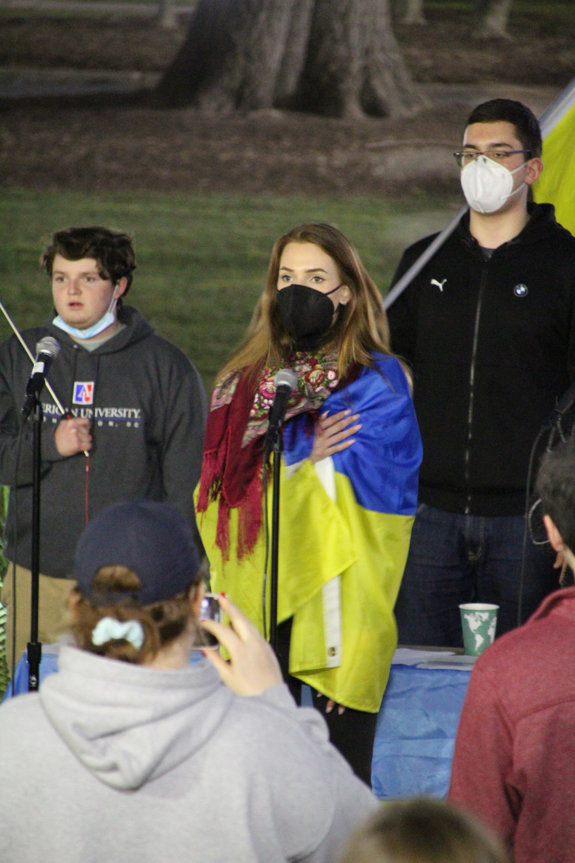 A woman sings the Ukrainian national anthem in Washington, D.C. on March 2, 2022. (Lia Chien/The Eagle)