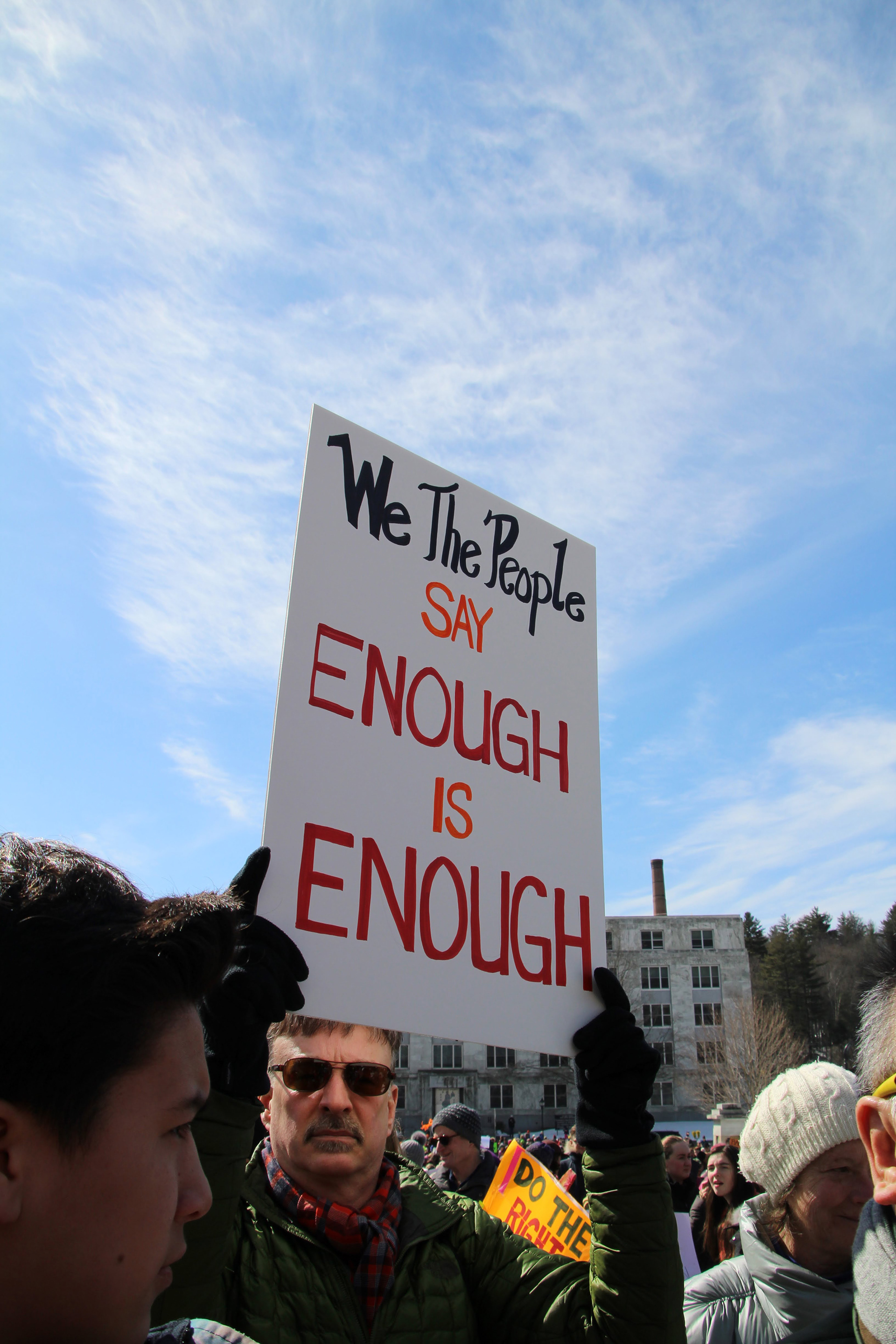A man raises a sign high above the crowd in Montpelier, Vt. on March 24, 2018. (Lia Chien)