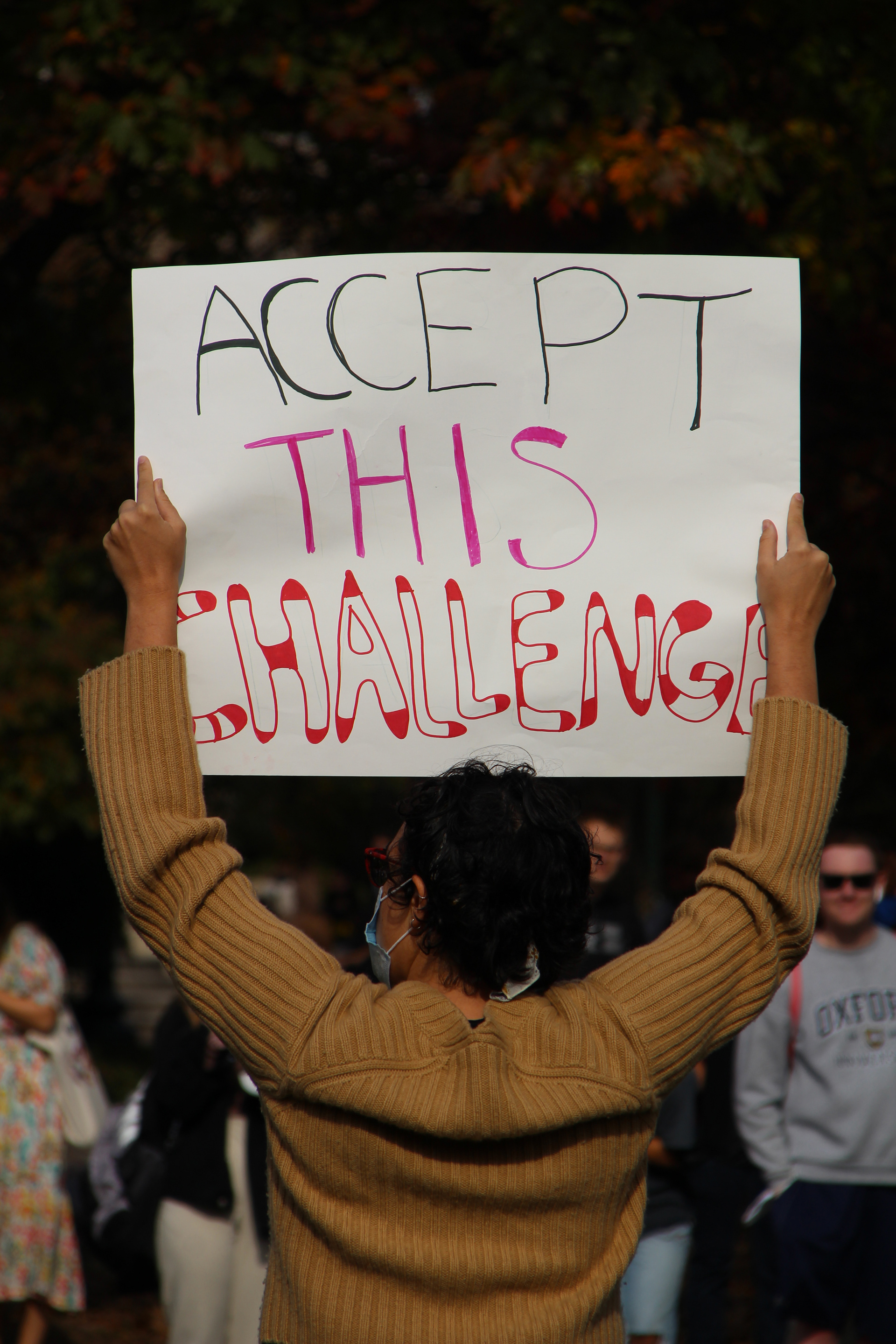 A woman holds a sign above her head at the protests for adjunct professors in Washington, D.C. on November 11, 2021. (Lia Chien/The Eagle)