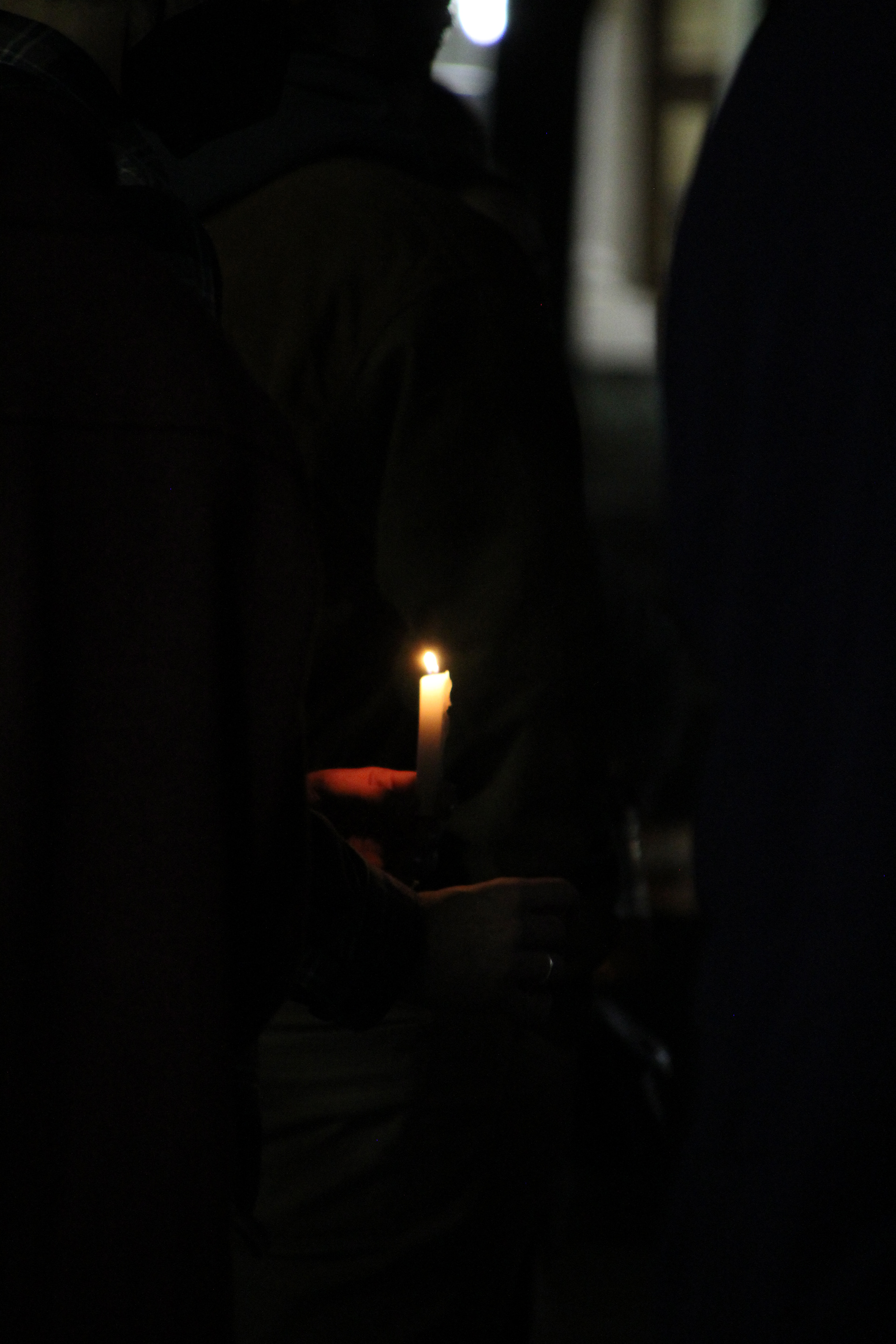 A candle flickers in the dark at a candlelight vigil for Ukraine in Washington, D.C. on March 2, 2022. (Lia Chien/The Eagle)