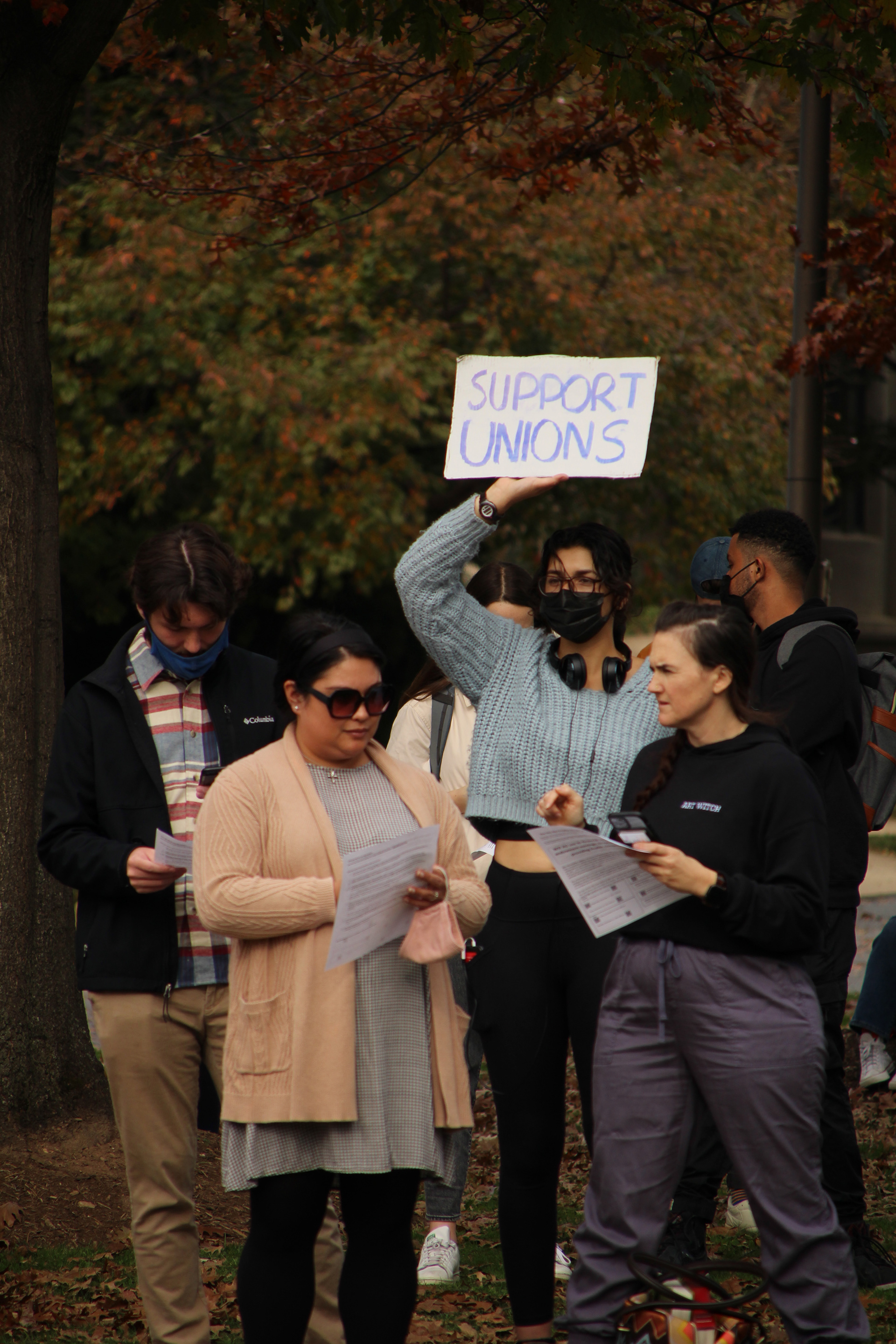 A student holds a sign in support of unions in Washington, D.C. on November 11, 2021. (Lia Chien/The Eagle)