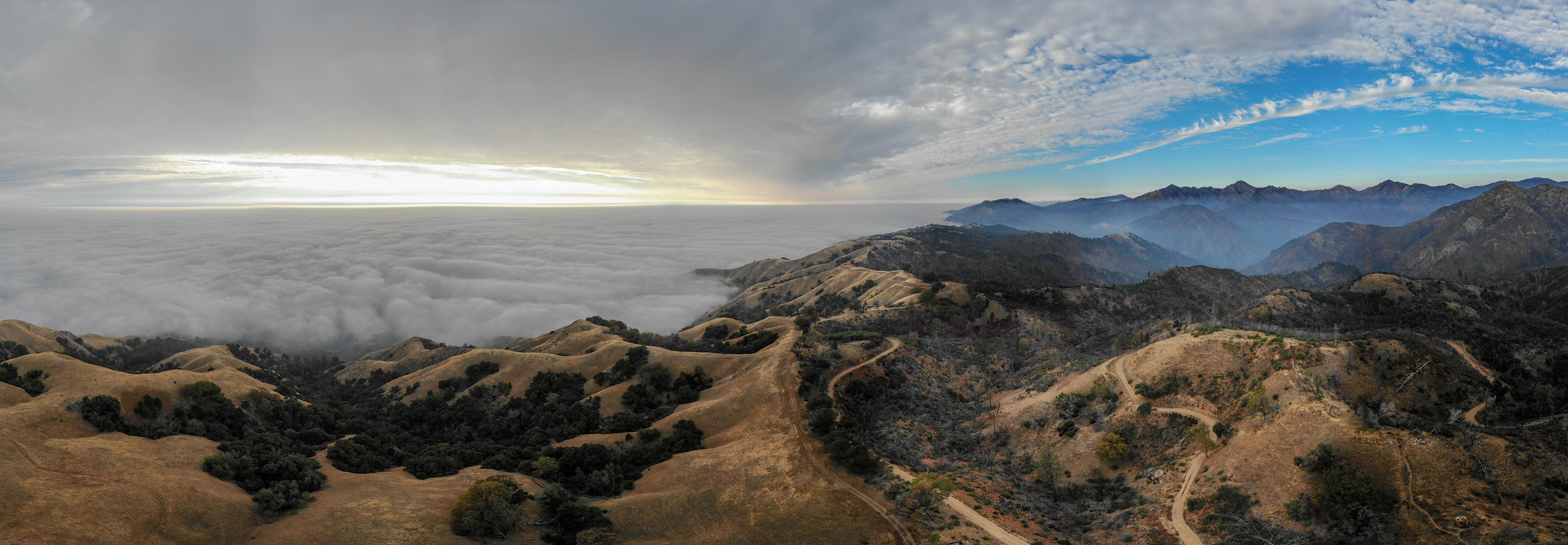River of smoke pouring from fire areas on the right towards the ocean on the left