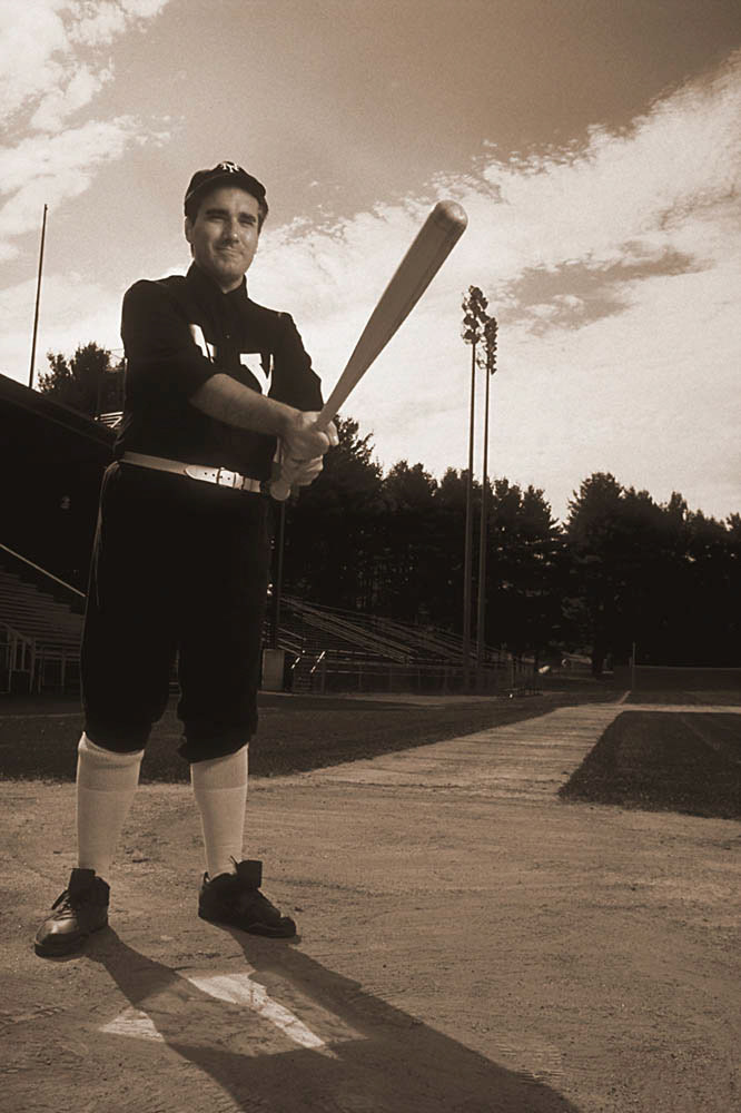 Sportscaster Keith Olbermann imitates one of his baseball heroes, Fred Merkle of the 1908 NY Giants. Photographed for Sports Illustrated Magazine