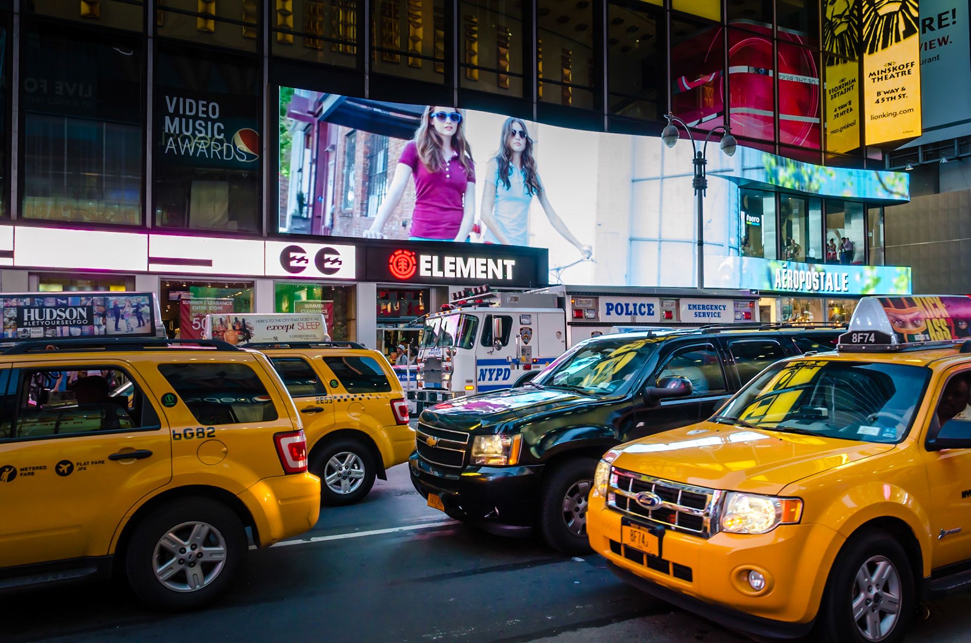 Time Square at night. Navigate between taxi and look around