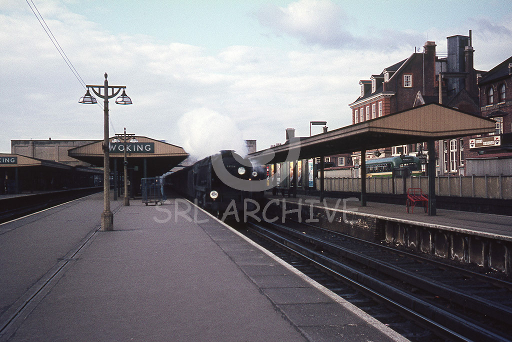 34104 'Bere Alston' at speed through Woking station with a Bournemouth-Waterloo express 11th March 1966 SRL No 948 