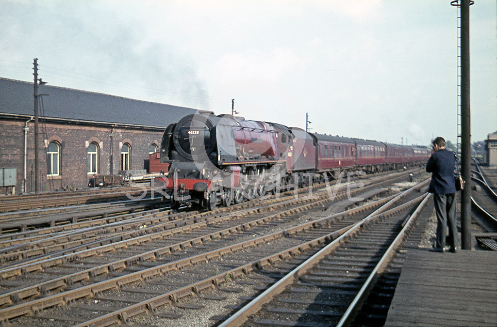 46238 City of Carlisle arriving into its namesake station 12th July 1962 passing the former LMS Goods depot south end of the station SRL No 577 