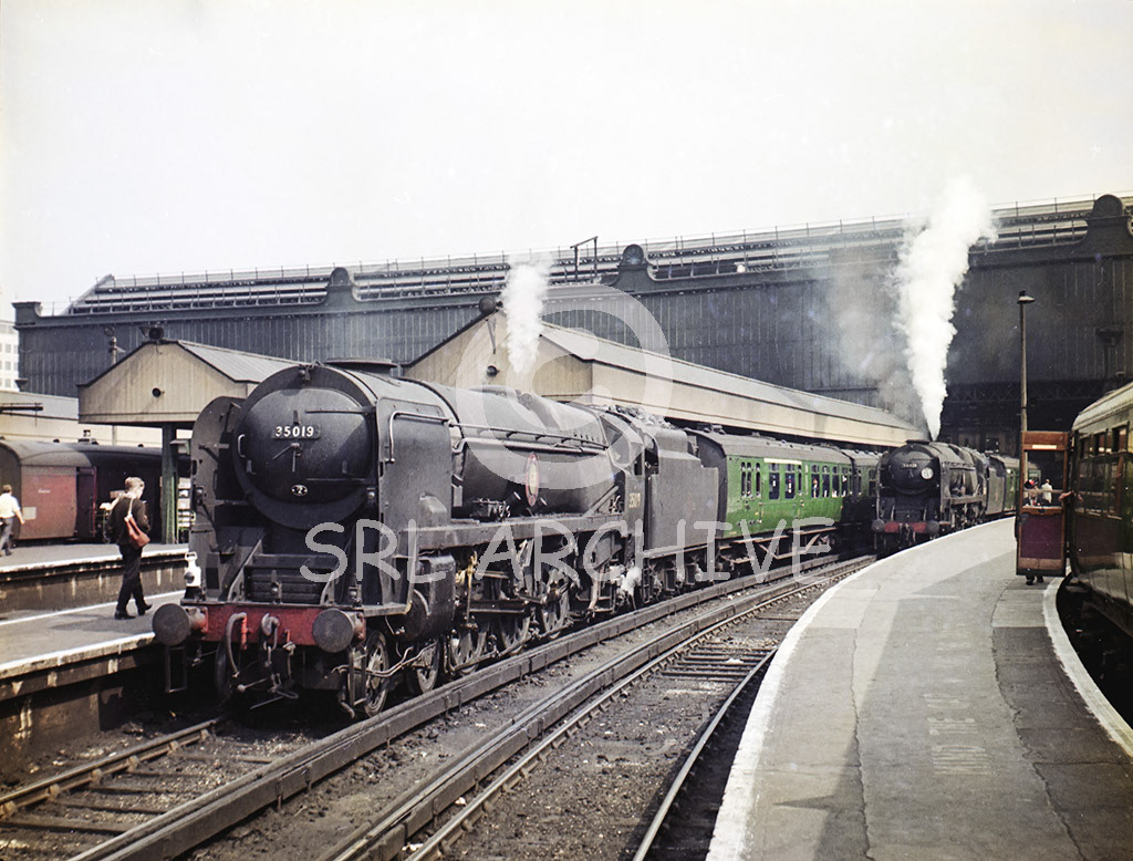 34021 'Dartmoor' waiting to depart from Waterloo station with the 10.54 to Basingstoke alonside Bullied MN Class No 35019 'French Line CGT' on the 11.00 to the south coast express in 1965 SRL No 1028 