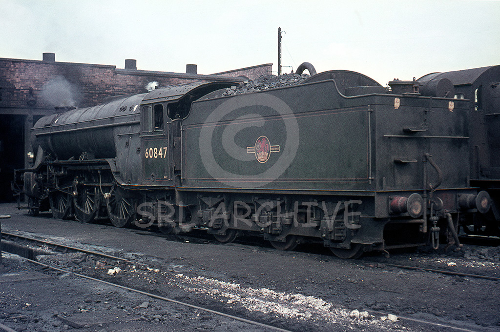 60847 'St Peter's School' on shed at Woodford Halse, Great Central in 1964. Throughout 1964 and the first two months of 1965, York allocated V2's had two daily (except Sunday) fitted freight turns from York to Woodford Halse, normally returning north a few hours later. Seen here now devoid of the nameplates. Only eight V2's carried names, seven named by the LNER and one by BR. SRL No 743 