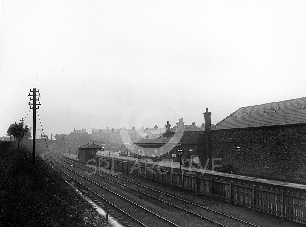 Rose Grove railway station near Burnley in 1896 with the stationmaster and porters looking on for the photographer SRL No 615 