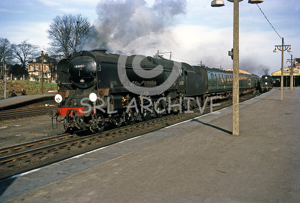 34097 'Holsworthy' at Basingstoke with a up express in the background un-rebuilt WCBoB in march 1965 SRL No 841 