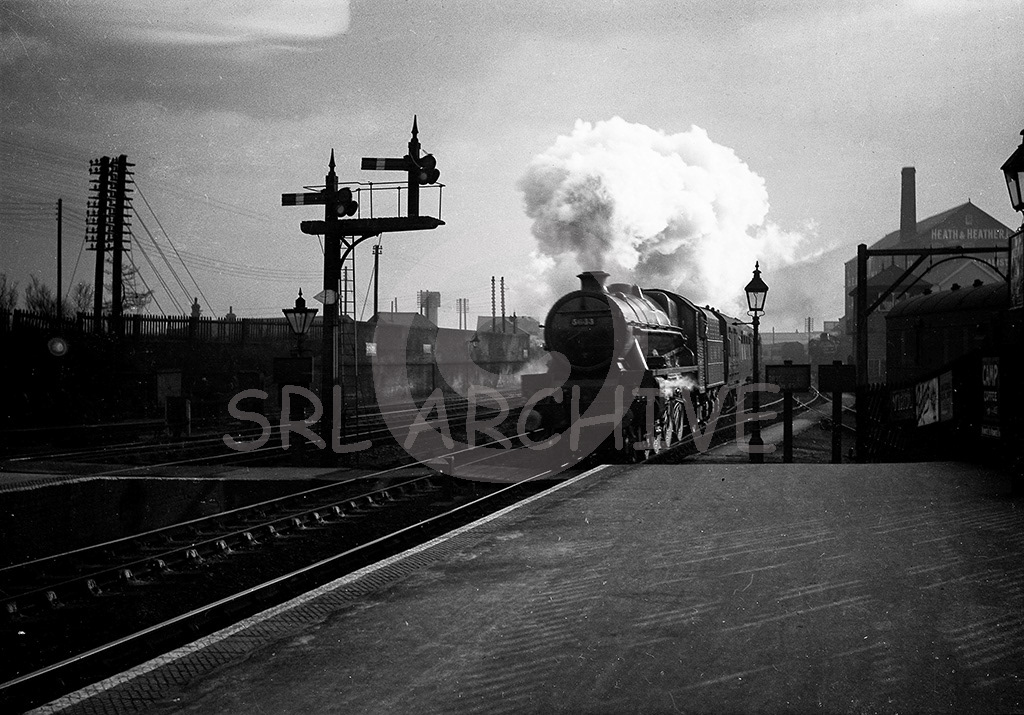 Stanier LMS Jubilee Class 4-6-0 No 5633 'Trans Jordan' later renamed 'Aden' in September 1946 seen here working through St albans station catching some wonderful light. Note the Heath & Heather Ltd warehouse on the right, herbal specialists and also the now Midland grade 11 signal box of 1863 which was restored by the local preservation society. SRL No 223 