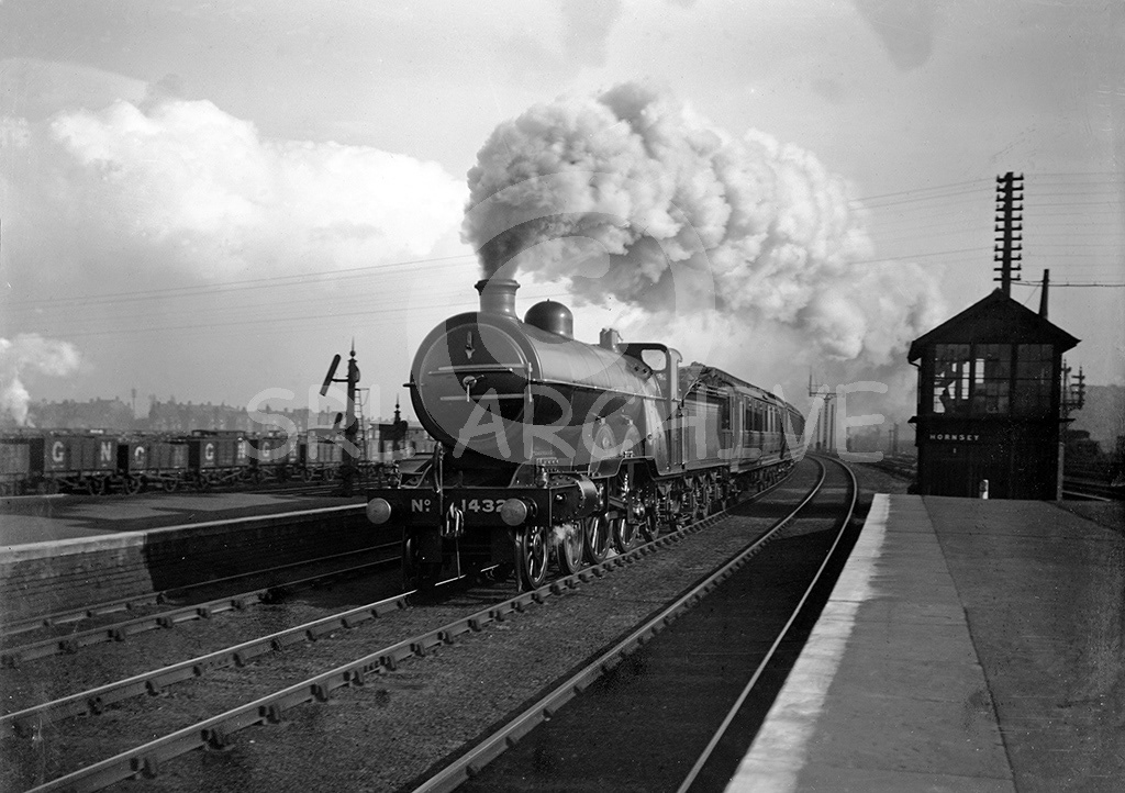 Ivatt C1 Class 4-4-2 No 1432 storming through Hornsey station on a down express pre November 1923 when it was renumbered 1432N. Note the GNR somersault signal and GN colliery wagons SRL No 5  