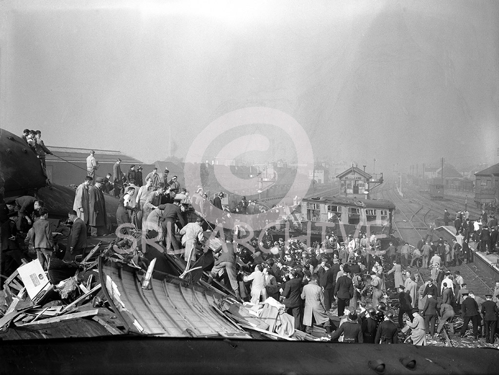 Harrow & Wealdstone rail crash 8th October 1952 published the following day by the Daily Mirror newspaper original glass negative showing rescue workers and local people trying to help the injured. SRL No 455 