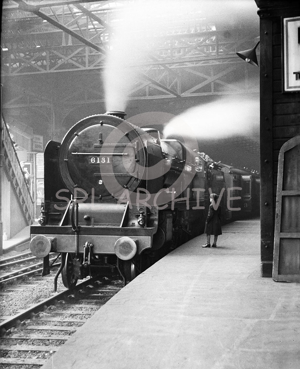 Stanier LMS Royal Scot Class 4-6-0 No 6131 'Planet' blowing off at Manchester, London Road station possibly ready to work The Mancunian to London Euston station around 1932. The driver looks on with just one young lad looking on(maybe a staged shot) as plenty of other spotters are to be seen on the far left stairs. Showing a 16 shed plate for Longsight MPD. Later renamed 'The Royal Warwickshire Regiment' in 1935-6. A wonderful shot taken by George John Drysdale of Seaforth, Liverpool/SRL No 213 