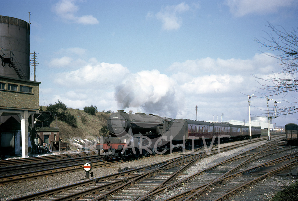 60814 at Stevenage with a Peterborough-London Kings Cross express 14th April 1962 passing the Langley water softening plant SRL No 76 