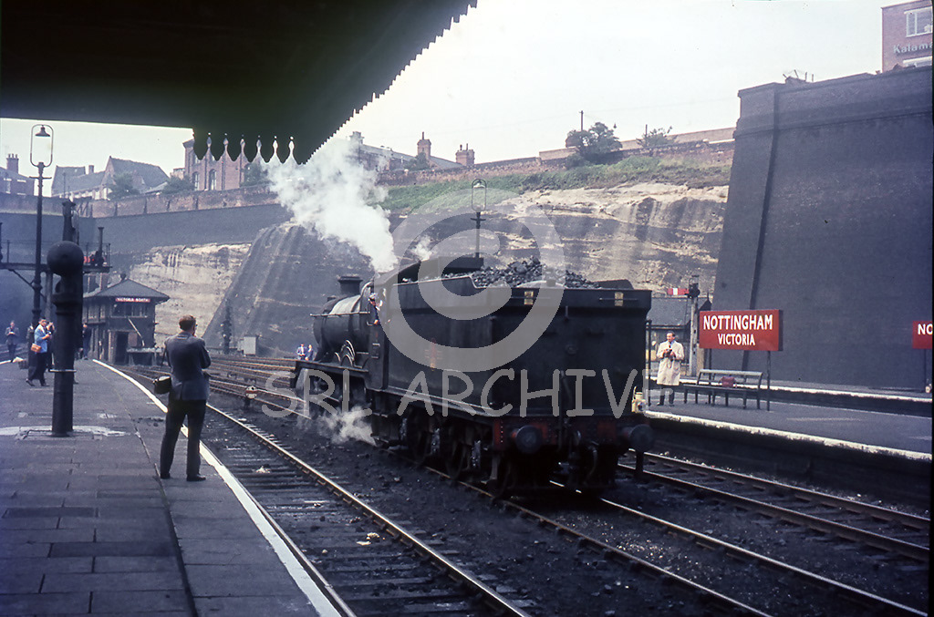 6911 'Holker Hall' at Nottingham Victoria station after arriving on the 1N63 Bournemouth West-Bradford Exchange express seen here waiting for the signal to advance north to the turntable where it came to grief(see SRL No 1121) Saturday 8th August 1964 SRL No 1118 