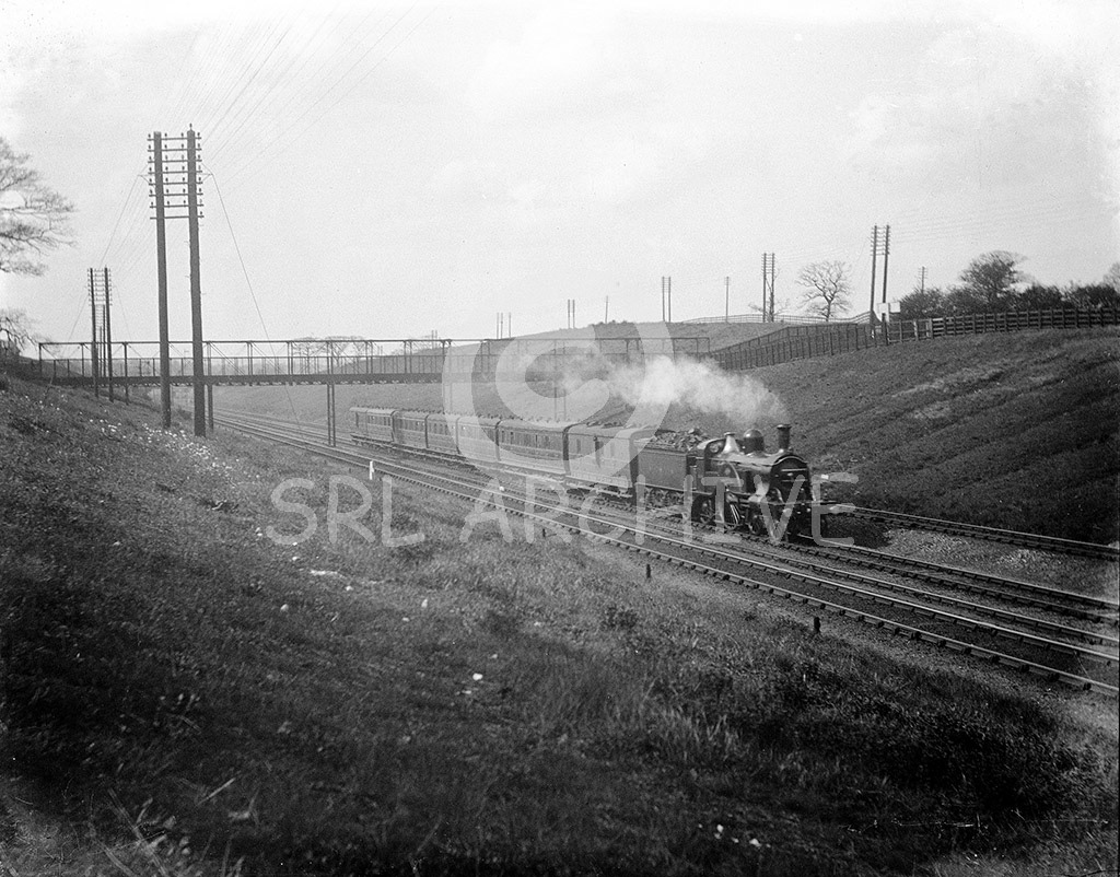 Stirling Single 4-2-2 No 544 at Oakleigh Park north of Wood green in 1899. Built at Doncaster Works in 1877 and withdrawn in October 1906. Seen here with the new domed boiler that was fitted to the locomotive in 1897. SRL No 1