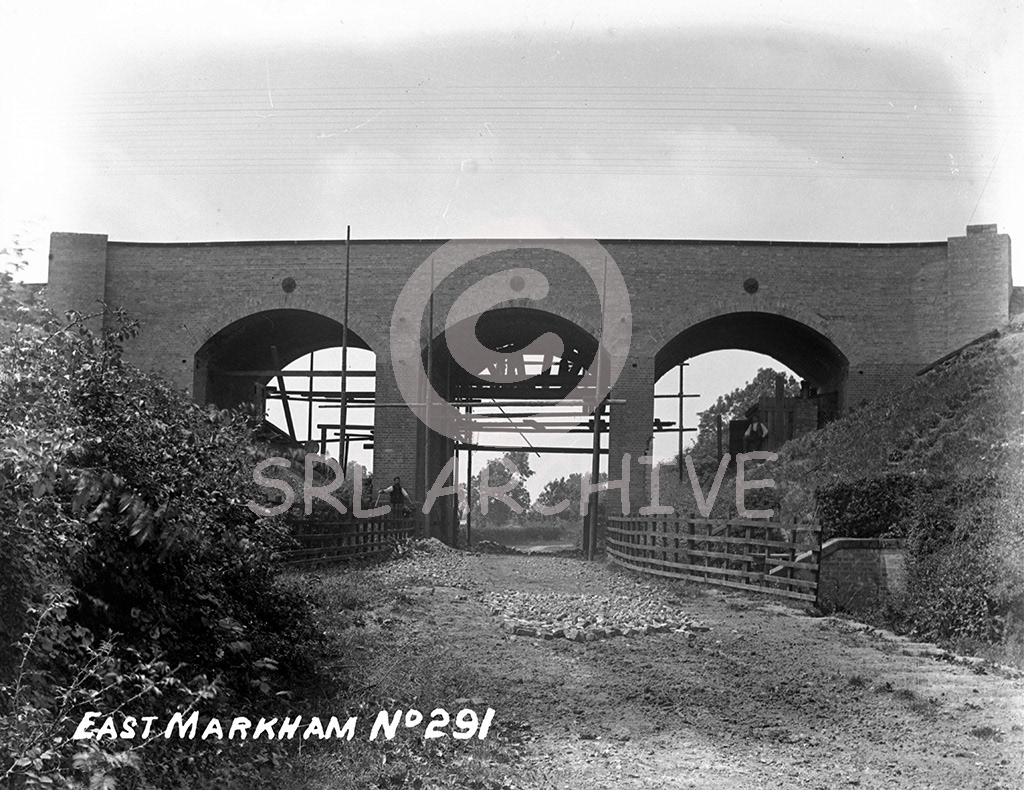 Quakerfield Road, East Markham in Nottinghamshire on the ECML. The London Gazette reported on the 22nd November 1889 " GNR,Alteration of roads in the county of Nottinghamshire. Extention of time for purchase of lands, and completion of widening of railways at Holloway, Grantham, Nottingham, Lofthouse Junction and for purpose of lands for Diversion of road at East Markham"  Other reports in 1886 "Diversion of road and abolition of level crossing at East Markham" Then in 1894 "widening from East Markham to Gamston, Markham Signal Box to Gamston Signal box both sides" SRL No 558 