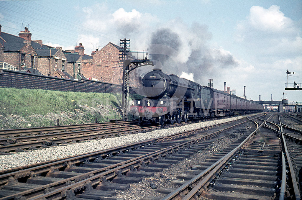 60963 passing leicester South Goods yard with the Nottingham-Neasden empty vans 18th April 1964. The photographer was waiting for 4472 which was working the Great Central rail tour on this particular day. SRL No 80 