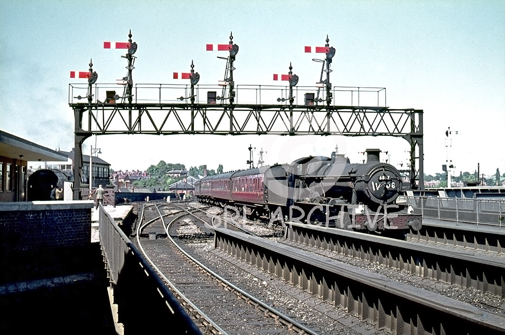 6867 'Peterston Grange' arriving at Shrewsbury under the wonderful signal gantry with the 10.42 Llandudno-Cardiff 20th July 1963. On the far left there looks to be a Stanier Duchess class locomotive SRL No 979  