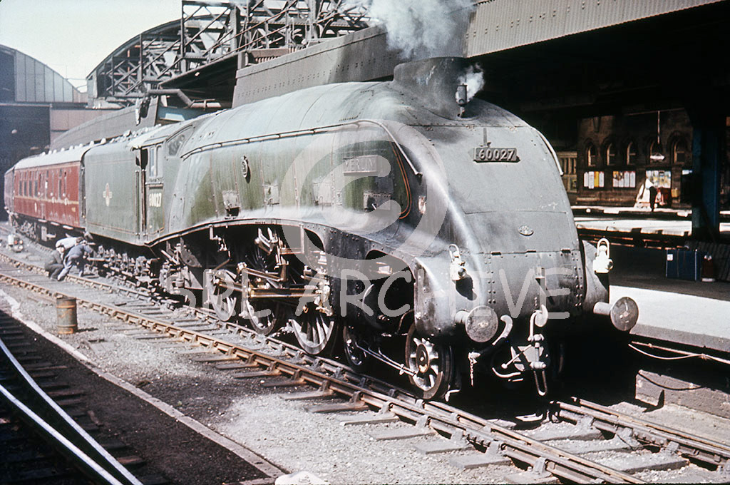 60027 'Merlin' at Newcastle Central station with problems with the crew taking a look at the bogie wheels on the tender August 1963 SRL No 79 