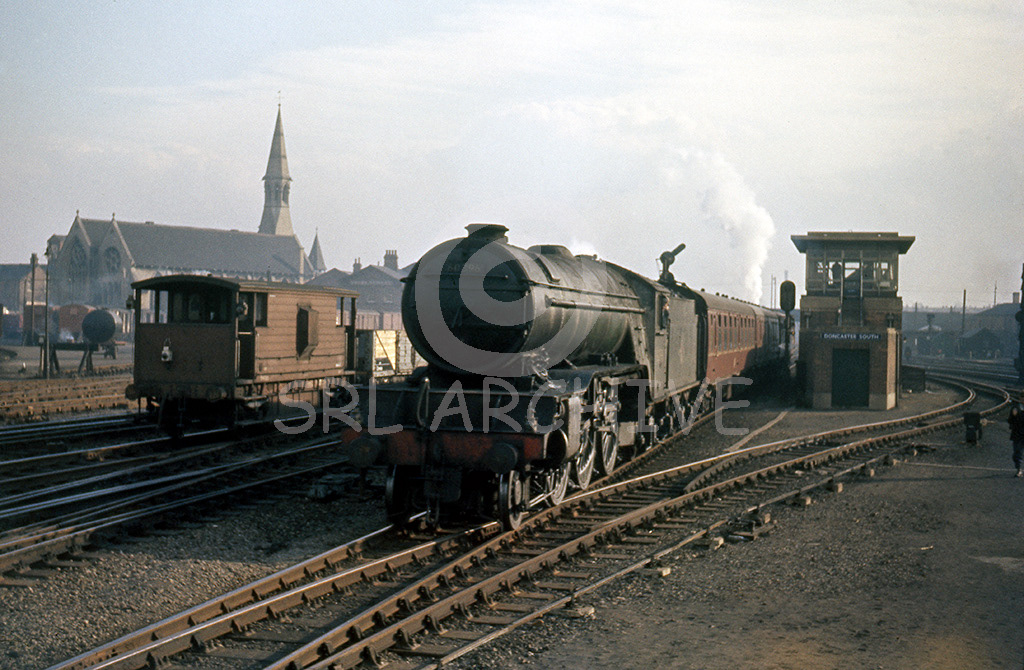 60896 working a down express passing Doncaster South signal box on the right and St,James church on the left 14th March 1962. It was withdrawn in September 1962 after the engine suffered from a catastrophic driving axle failure and scrapped in October SRL No 696 