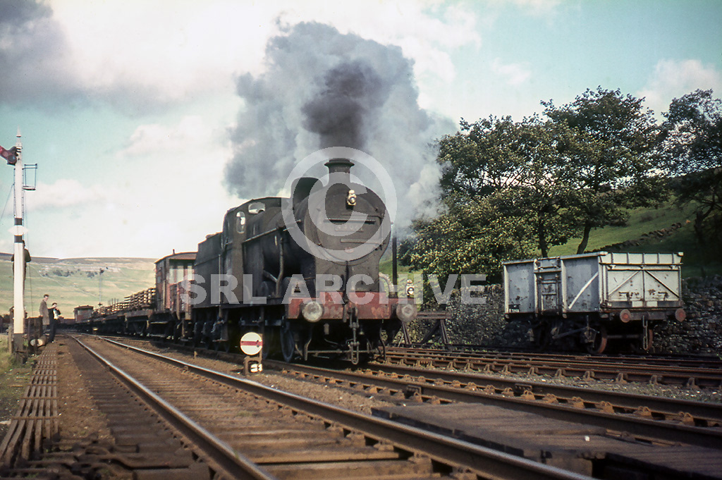 44061 of 24G Skipton shed is seen at Garsdale station on the Settle & Carlisle Railway with a small Up freight 27th September 1963. SRL No 1168 