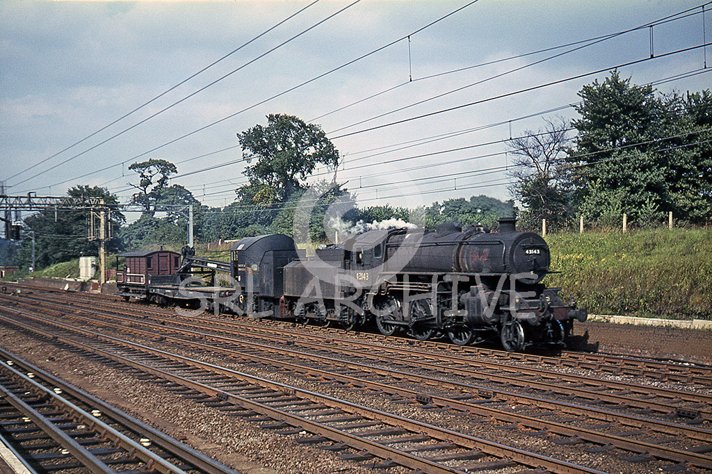 43143 with an Up engineering train consisting of a steam breakdown crane passing through Carpenders Park station on the WCML north of Harrow 29th August 1964 SRL No 852 