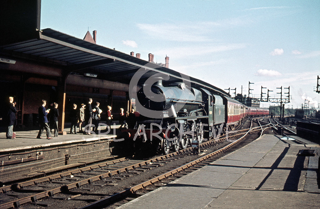 45634 Trinidad at Preston station with a northbound express in this lovely shot with spotters on the platform a wonderful signal gantry in the background date 1958 SRL No 772 