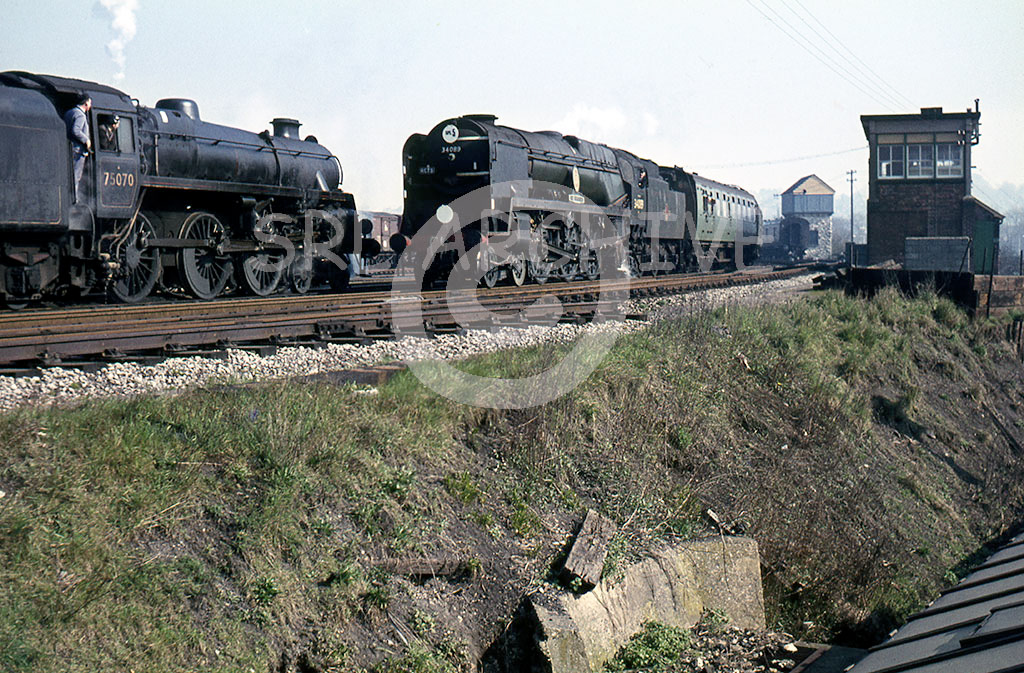 34089 '602 Squadron' arrives at Salisbury from London Waterloo on the RCTS Solent rail tour 20th March 1966 with the crew on Standard class 4 75070 looking on SRL No 337 