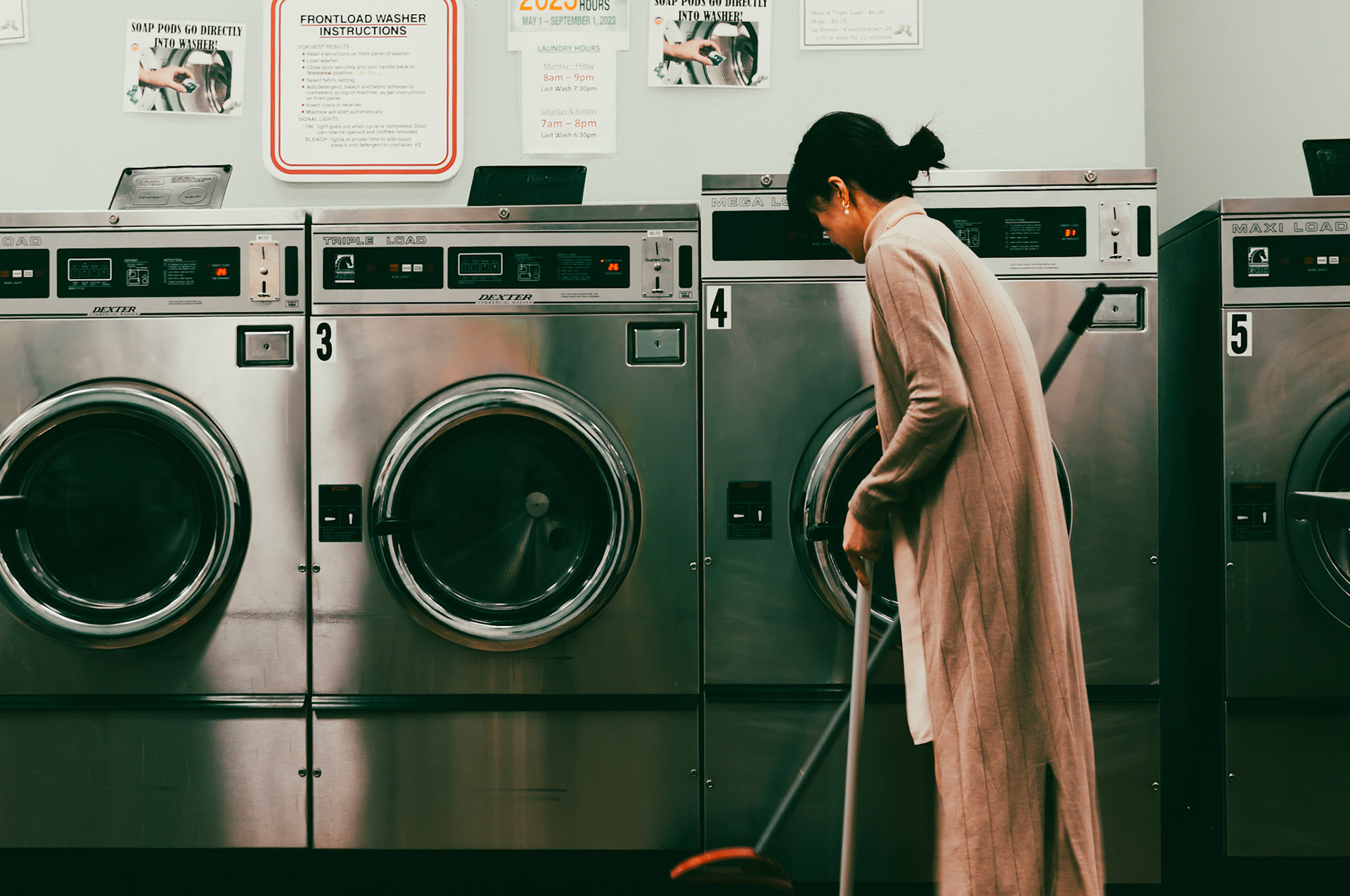 Woman cleaning Public Laundromat