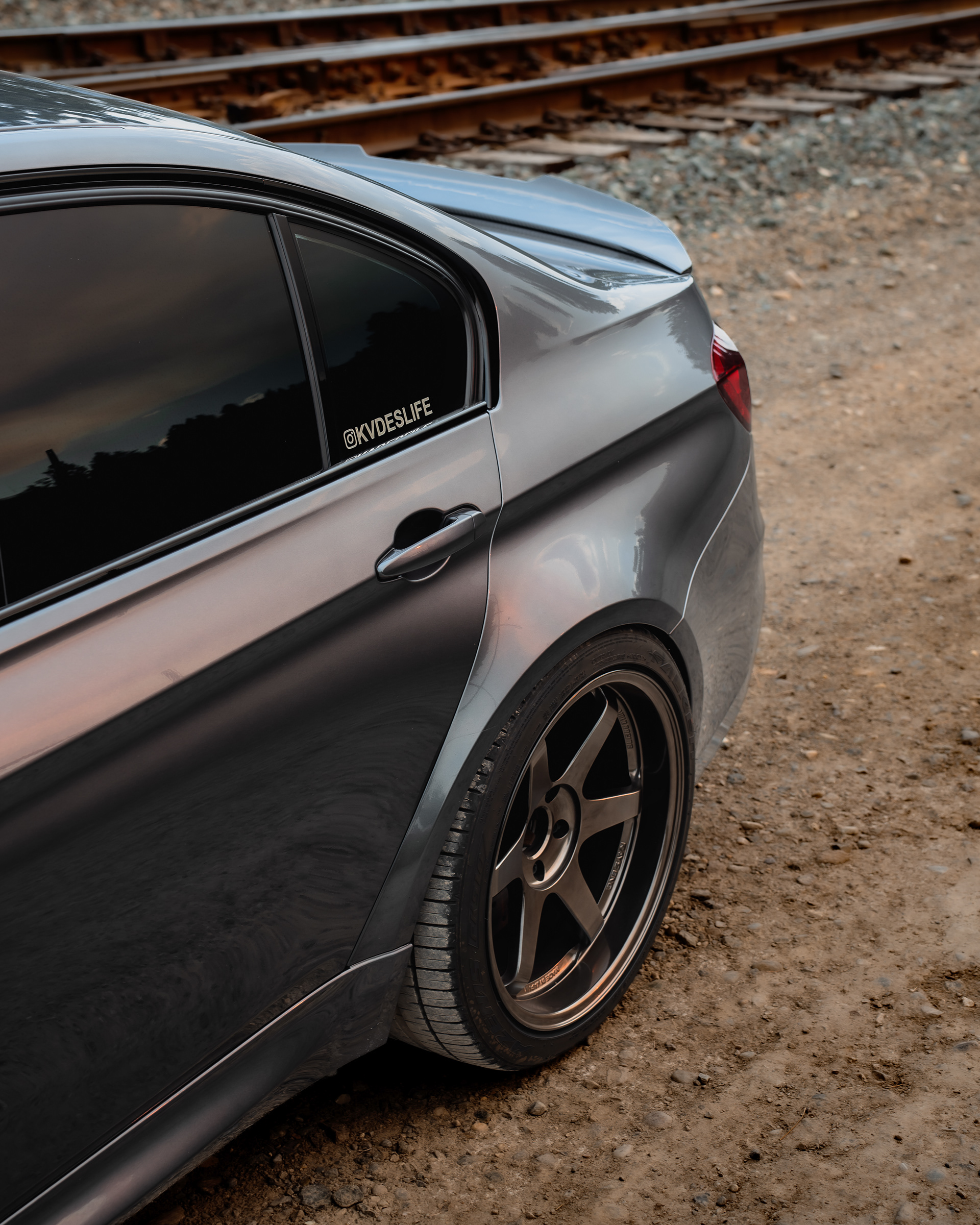 Side detail composition highlighting wheel fitment, body lines, and branded accents.