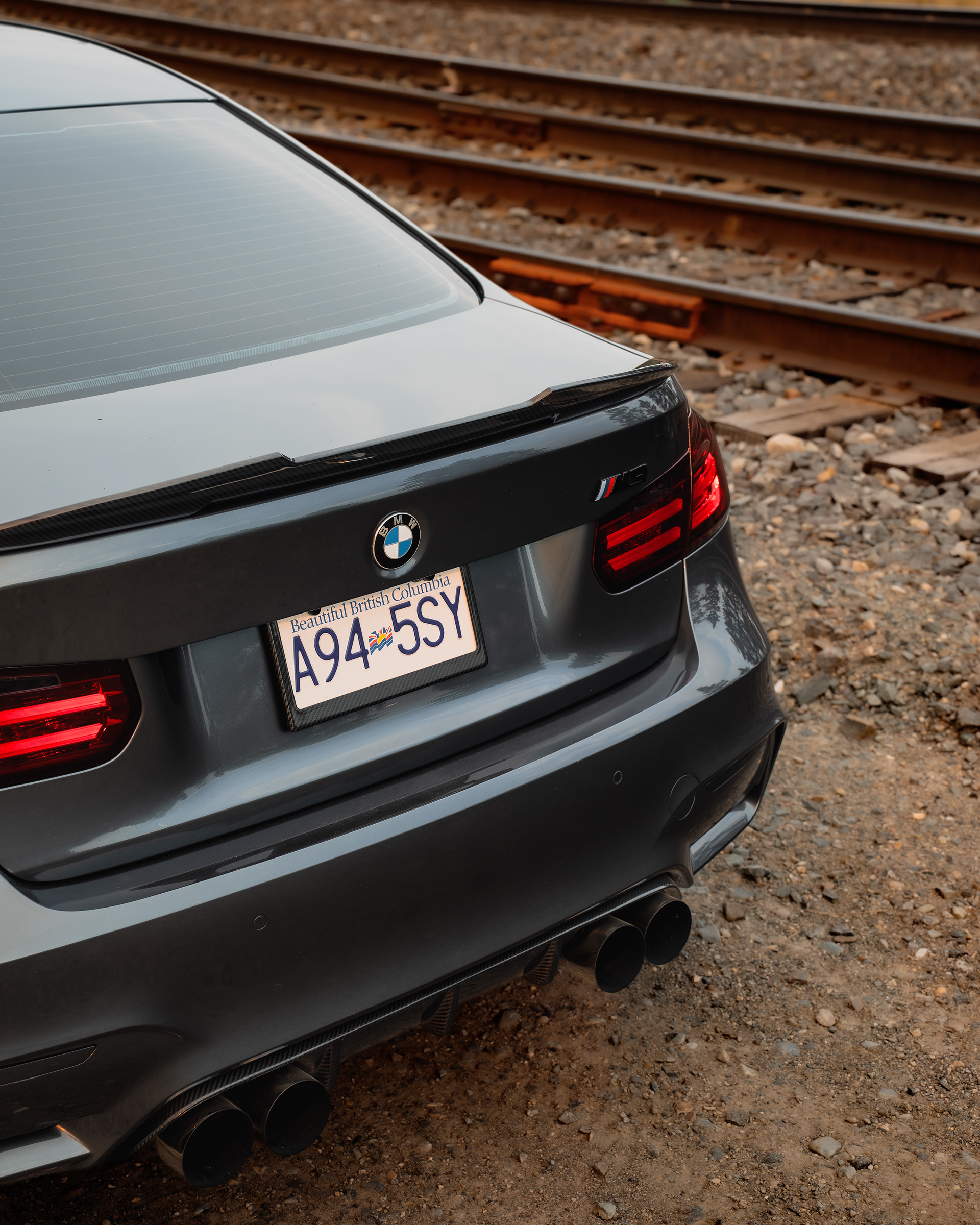 Rear detail shot showcasing the taillights, spoiler, exhaust, and overall finish.