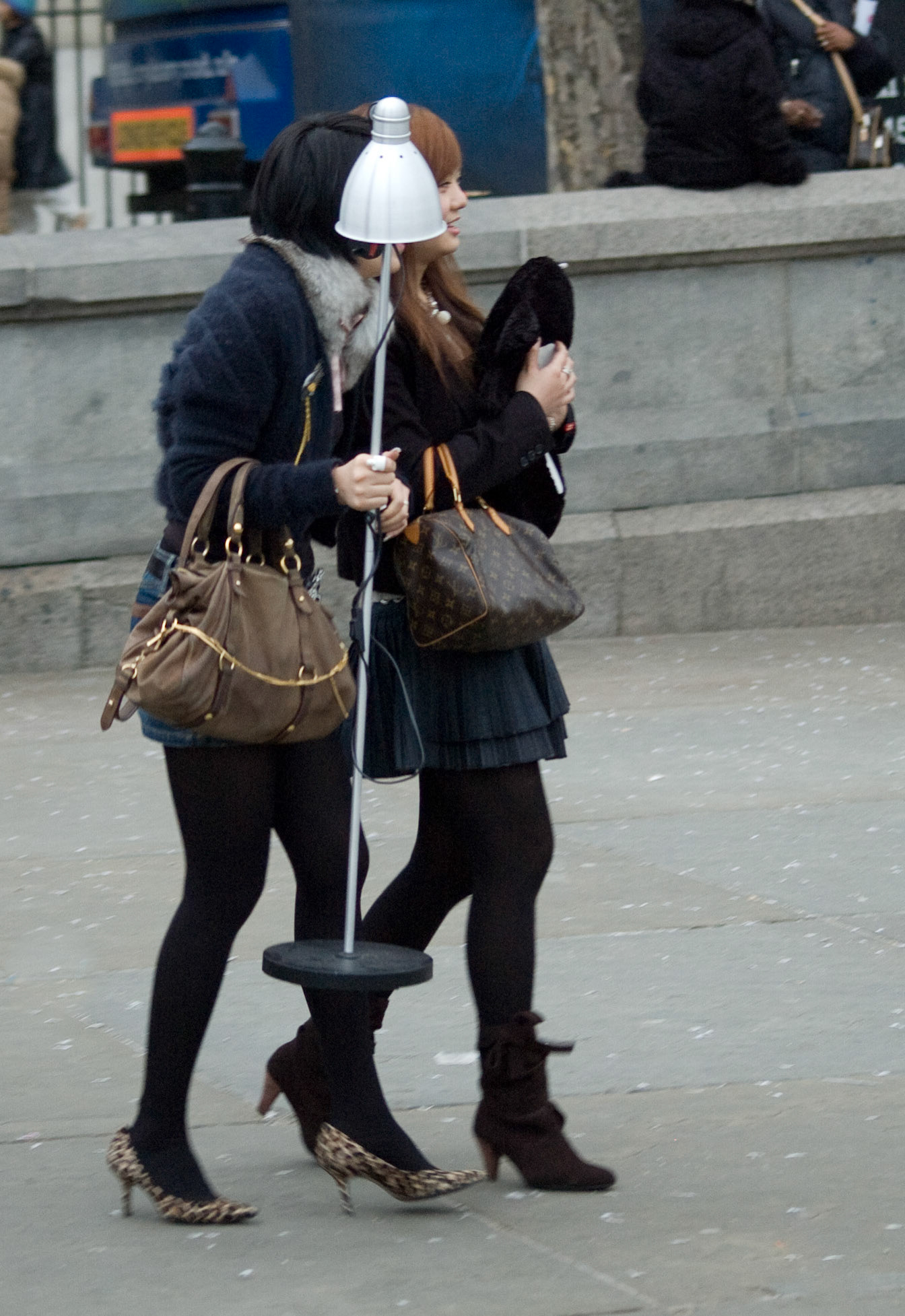 Two women with lamp, Trafalgar Square, London, February 2007
