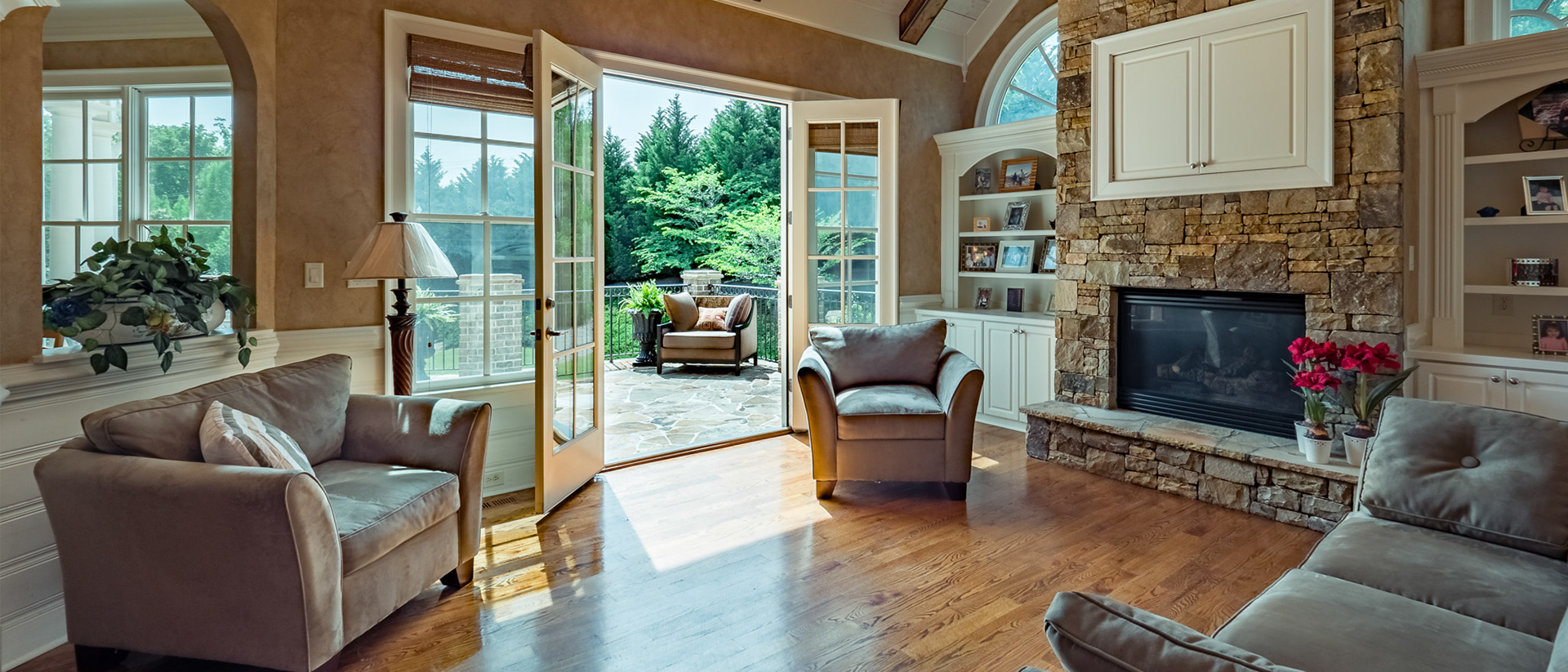 Let the outdoors in through these French doors and across the stone fireplace.  A casual, yet elegant keeping room in The Manor Golf and Country Club in Milton, GA.