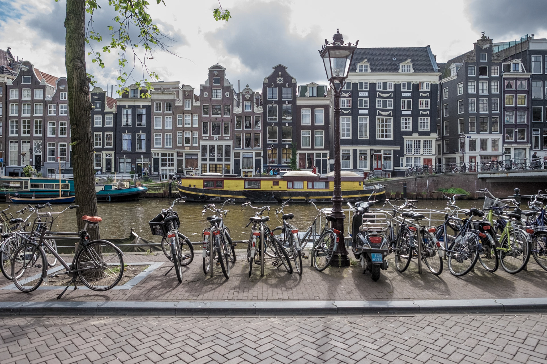 A cloudy, late summer day in amsterdam. Parking bicycles at a canal.