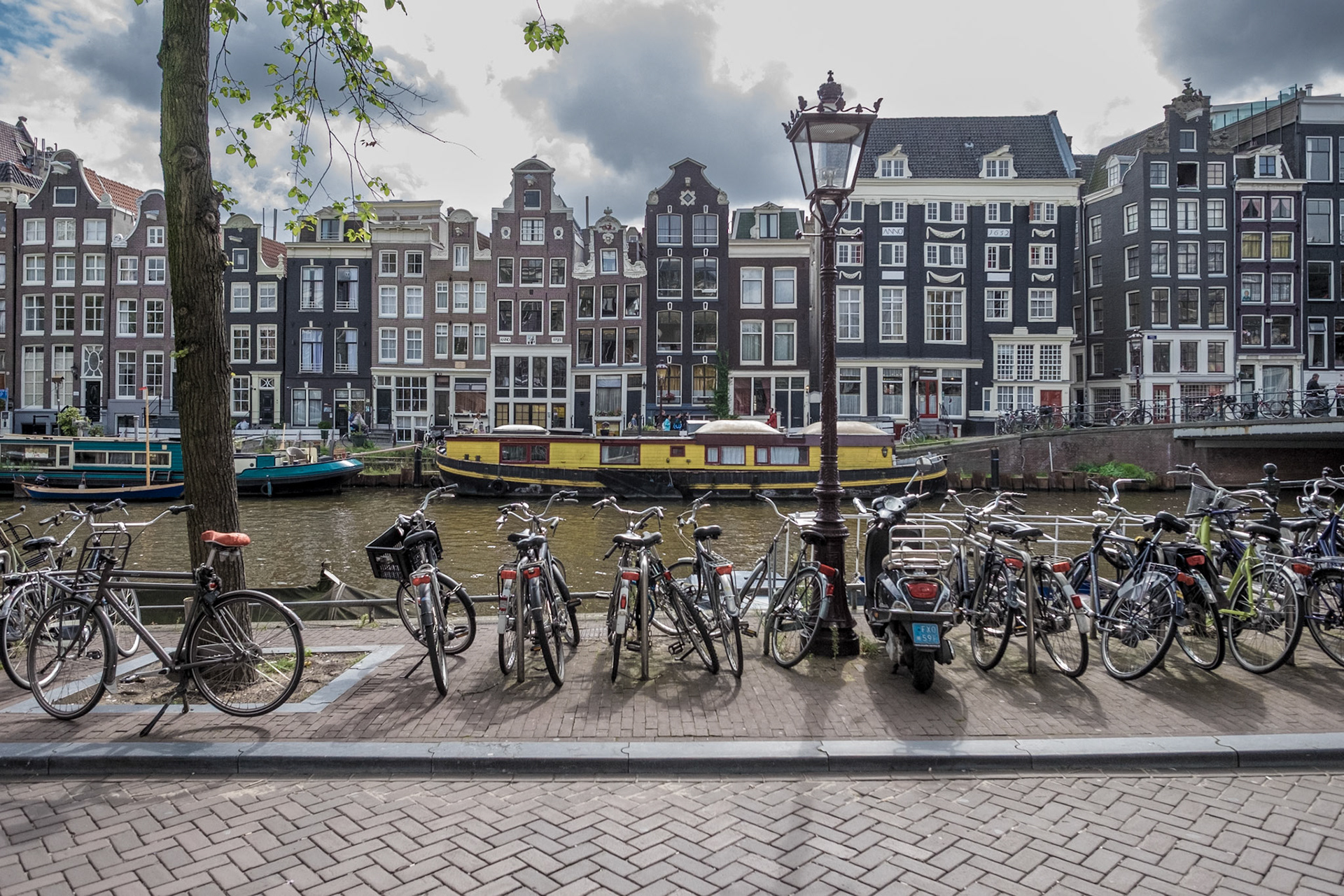 A cloudy, late summer day in amsterdam. Parking bicycles at a canal.